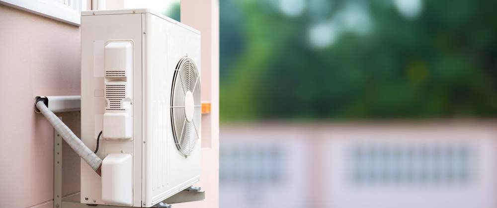 Photo of an airconditioner and heater on side of the building