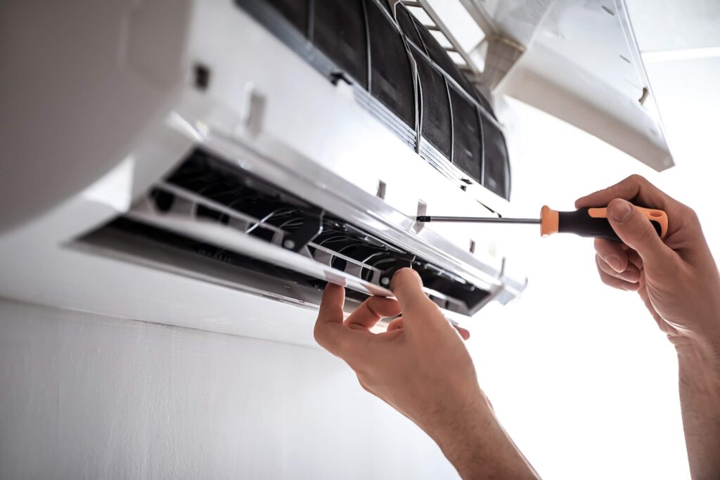 Electrician repairing indoor air conditioning